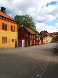 Empty road with buildings in background