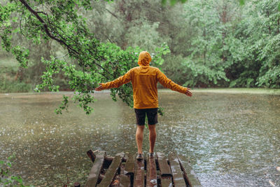 Rear view of a boy standing in water