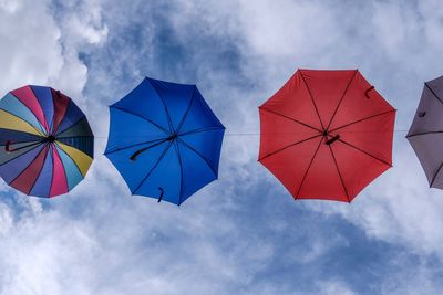Low angle view of umbrellas against sky