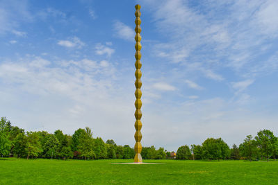 Scenic view of grassy field against sky