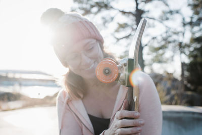 Skateboard wheel in the sunshine with woman in the background