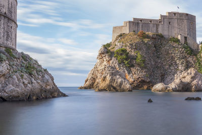 Panoramic view of sea and buildings against sky