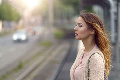 Close-up portrait of young woman in city