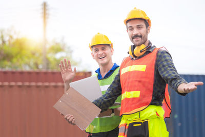 Portrait of smiling man standing against built structure