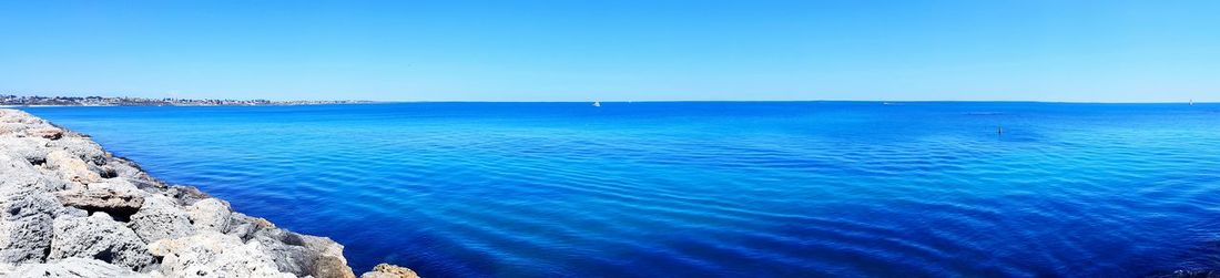 View of calm blue sea against clear sky