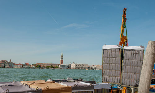 Crane unloading metal baskets with hotel linen in venice