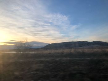 Scenic view of field against sky during sunset