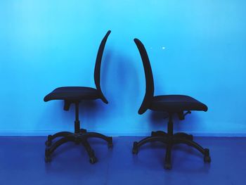Two chairs in blue room