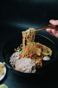 Cropped hand of person preparing food