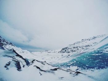 Scenic view of snowcapped mountains against clear sky