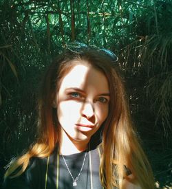 Portrait of beautiful young woman in forest