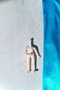 High angle view of female sculpture on concrete wall