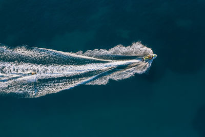 Aerial view of people jet boating in sea