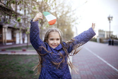 Portrait of cute girl holding umbrella