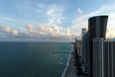 Panoramic view of sea and buildings against sky