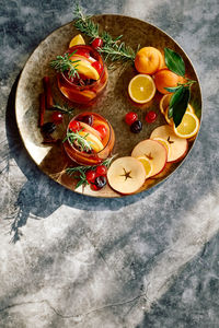 Mulled wine or christmas sangria with aromatic spices, apple, cherry and citrus fruits.