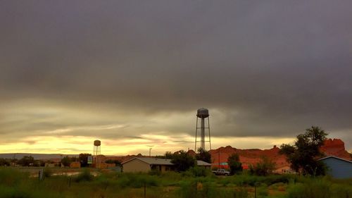 Built structure on field against cloudy sky