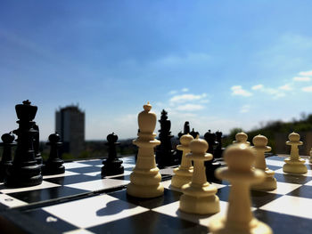 Close-up of chess board against the sky