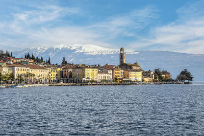 The lakeside of salò with the monte baldo in background