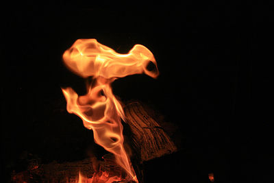 Close-up of illuminated fire against black background