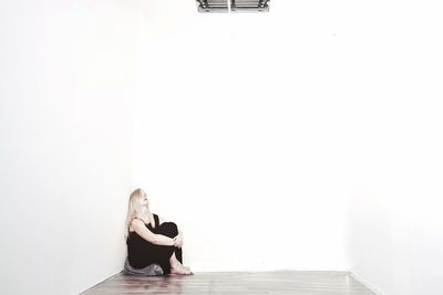 Woman sitting on wall