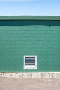 Air vent on green wall