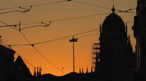 Low angle view of silhouette church against sky at sunset