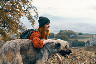 Woman wearing hat on land against sky