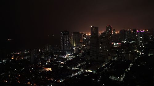 High angle view of illuminated buildings in city at night