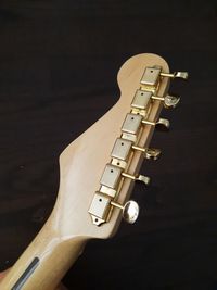 High angle view of guitar on table against black background