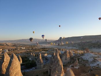 View of hot air balloons flying over rocks