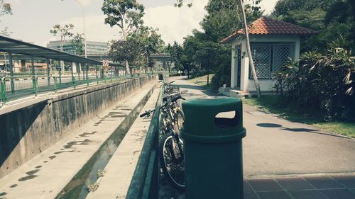 Empty road amidst buildings in city