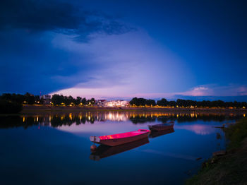 Scenic view of lake against sky at night