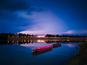 Scenic view of river against sky at night