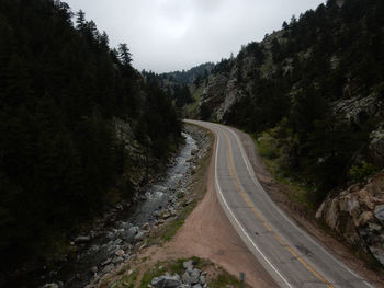 Road amidst mountains against sky