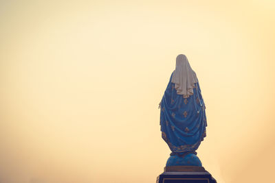 Low angle view of statue against sky during sunset