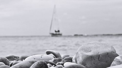 Close-up of stones on beach against sky