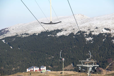 Ski lift over mountains against sky