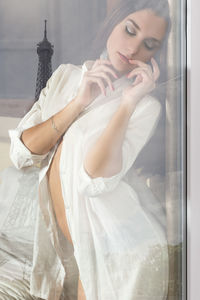 Beautiful woman seen through glass window