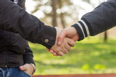 Midsection of man holding hands