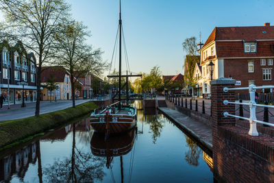 Canal amidst buildings against sky