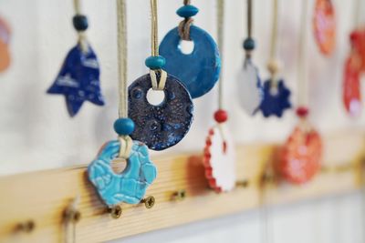 Close-up of decoration hanging on wood at home