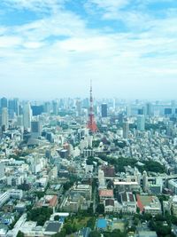 High angle view of city buildings against cloudy sky