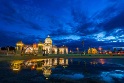 Illuminated building against sky at night