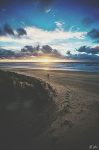 View of beach against cloudy sky