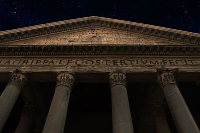 Low angle view of illuminated building against sky