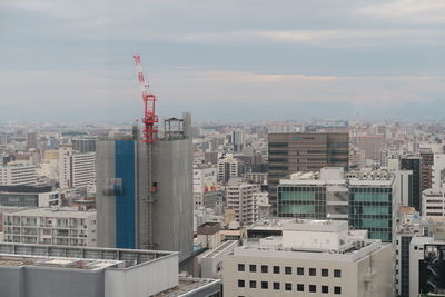 High angle view of buildings in city against sky