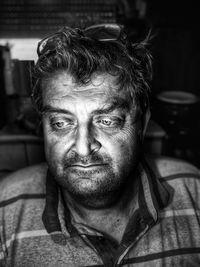 Close-up portrait of man sitting outdoors