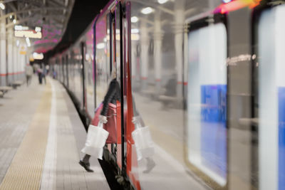 Low section of woman entering in train