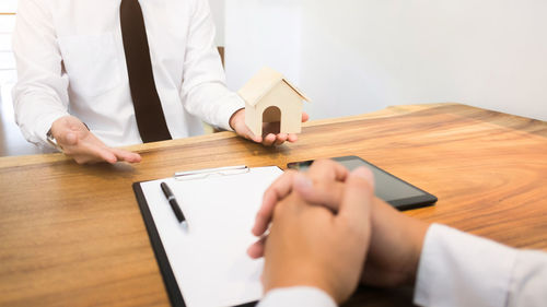 Midsection of man working on table